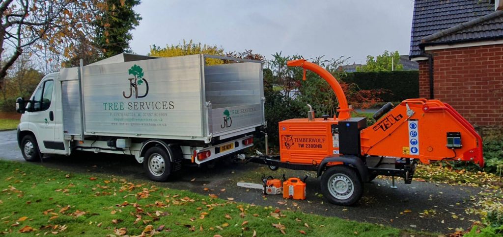 JD Tree Services tree surgeons in Wrexham working with chipper and work truck on site